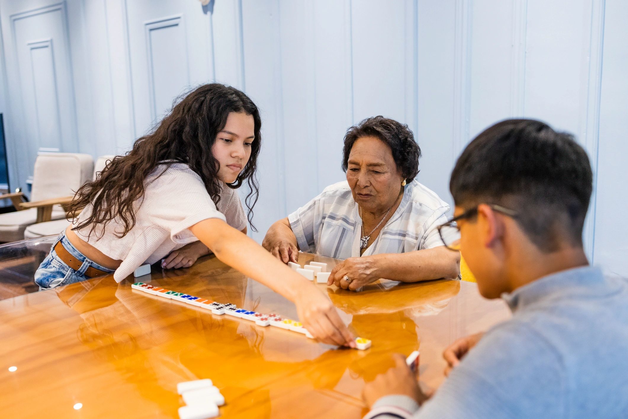 Friends gathered around a table for a tile game night