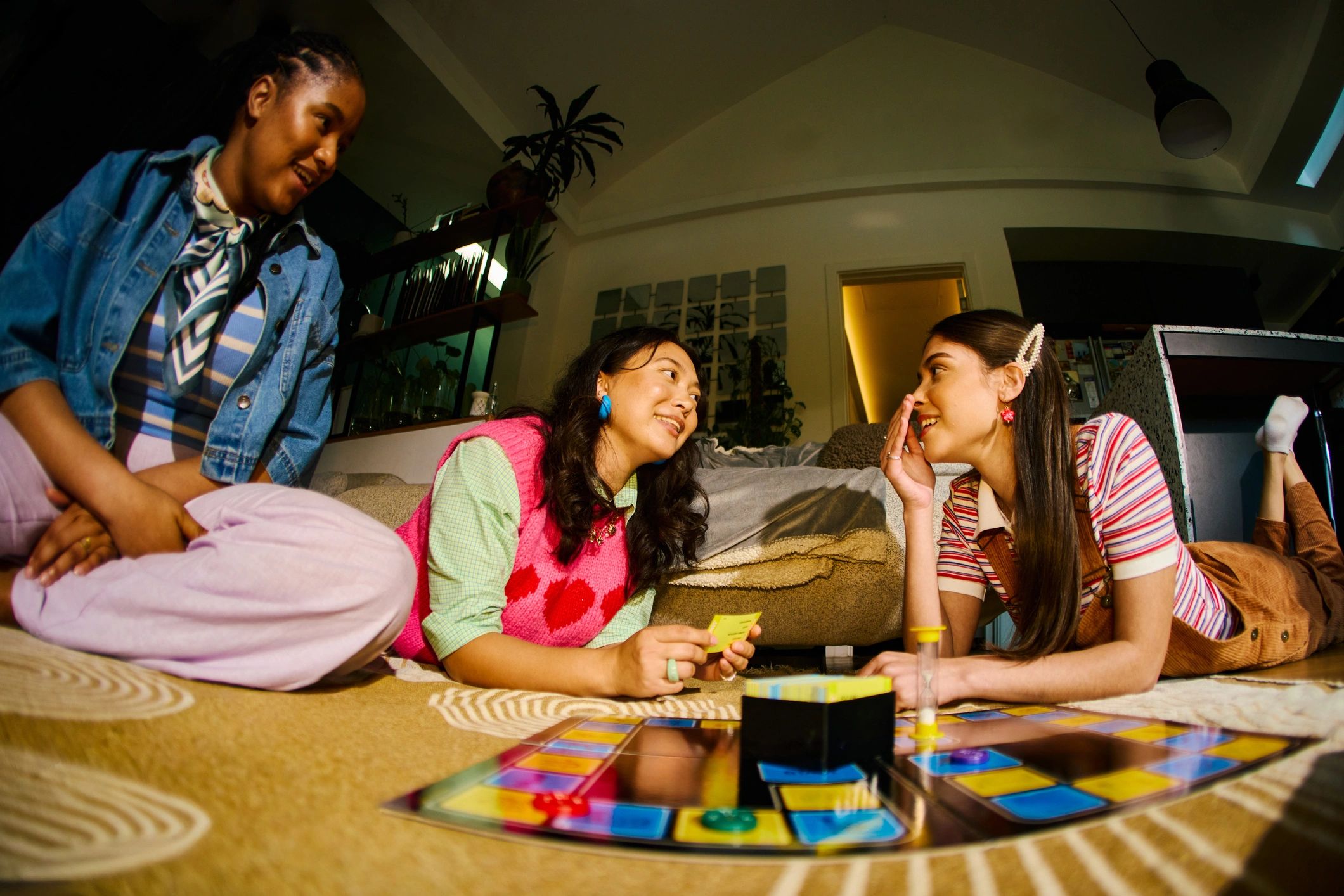 Friends laughing together during a board game night
